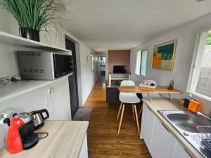 a small kitchen with a sink and a table at Contain'House Paradise in Les Abymes