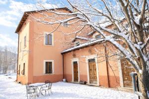 a house with chairs and a table in the snow at Santocasale in Rocca di Mezzo