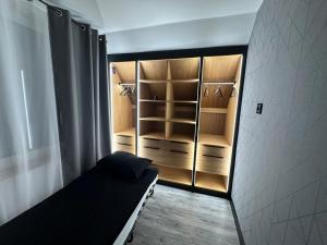 a walk in closet with a bed in a room at Slow Time in Morąg
