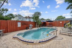 a swimming pool with a slide in a backyard at Relaxing Poolside Condo in Savannah