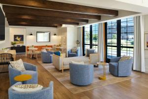 a living room with couches and chairs and a table at Tiller House, Laguna Hills, a Tribute Portfolio Hotel in Laguna Hills +46 photos