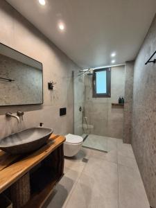 a bathroom with a sink and a toilet and a shower at Milion Living Residences in Parga +87 photos