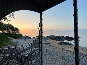 a bench on a beach with a sunset in the background at Apartment B in Bangor