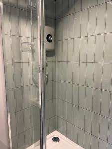 a shower with a glass door in a bathroom at Apartment B in Bangor