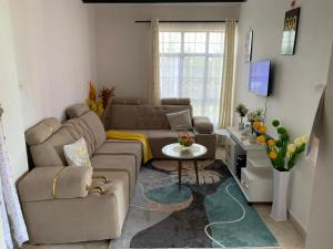 a living room with a couch and a table at Nanako Comforts in Kitengela 