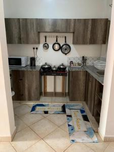 a kitchen with a counter with pots and pans at Nanako Comforts in Kitengela 