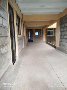 an empty hallway of a school building with a sidewalk at Nanako Comforts in Kitengela  +2 photos