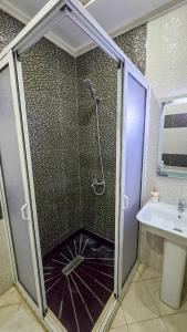 a shower with a glass door in a bathroom at Abraj Dubai - Premium 3BR Stay in Heart of Larache in Larache +26 photos