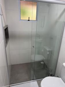 a shower with a glass door in a bathroom at Pousada da Praça in Rosário do Sul