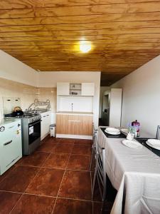 a kitchen with a table with a table cloth on it at El Floramento in San Pedro de Atacama