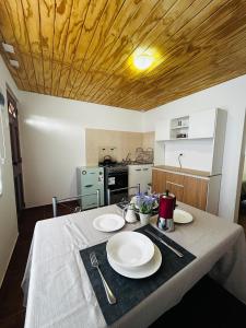 a kitchen with a table with plates on it at El Floramento in San Pedro de Atacama