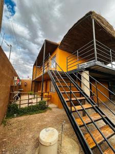 a building with a staircase in front of it at El Floramento in San Pedro de Atacama