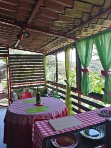a dining room with a table with plates on it at The Hummingbird house, Costa Rica in Atenas