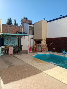a patio with a pool and a table and chairs at casa azul in Plottier