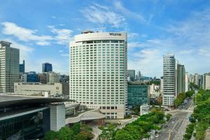 a view of a tall white building in a city at The Westin Seoul Parnas in Seoul