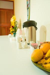 a plate of bananas on a counter with flowers at Valle Hermoso in San Ramón +11 photos