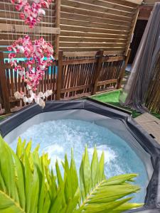 a hot tub in the middle of a garden at Gwada fun habitation in Saint-Claude