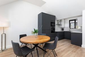 a kitchen with a wooden table and chairs in a room at Howth Village Cottage in Howth