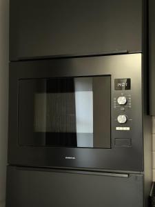 a microwave oven sitting on top of a refrigerator at B&B D'n Optie in Druten +7 photos