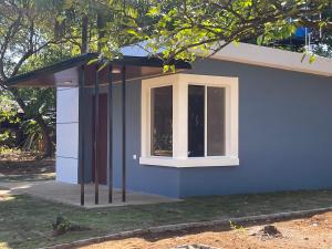 a small house with a window on the side of it at Quinta el Refugio in Managua