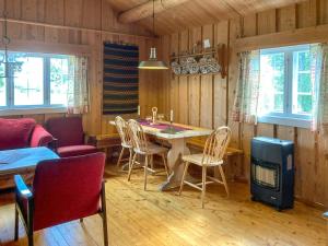 a dining room with a table and chairs at Simple Mountain Cabin Near Vinstra in Vinstra