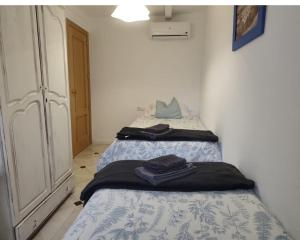 a bedroom with two beds with towels on them at En Poniente in La Línea de la Concepción