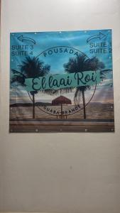 a picture of a sign hanging on a wall at El Laai Roi in Iguaba Grande