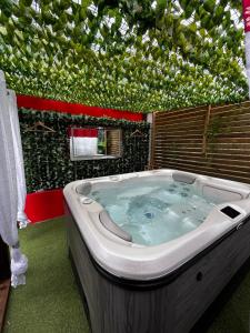 a large jacuzzi tub in a room with a wall at Gwada fun habitation in Saint-Claude