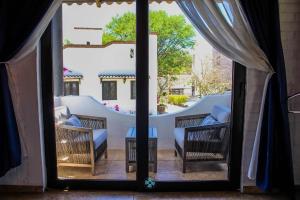 an open door to a patio with chairs and a table at Yolihuani Relax Resort in Calvillo