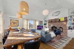 a living room with a dining table and a fireplace at West End Haven w/ Modern Kitchen + Private Yard in Provincetown