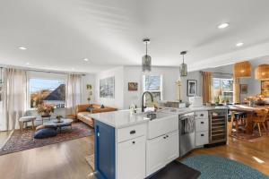 a kitchen and a living room with a couch at West End Haven w/ Modern Kitchen + Private Yard in Provincetown