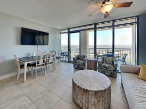 a living room with a couch and a table at Palisade Palms TW1012 - Sea Escape in Galveston