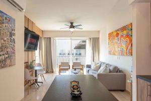 a living room with a couch and a table at Life Bucerias in Bucerías