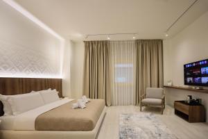 a bedroom with a bed with a teddy bear on it at A Gallery Hotel in Shkodër
