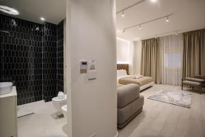a living room with a couch and a bed in a room at A Gallery Hotel in Shkodër +281 photos