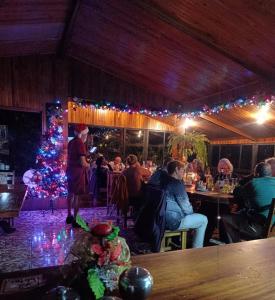 a restaurant with a christmas tree and people sitting at tables at Belcruz family lodge in Monteverde Costa Rica
