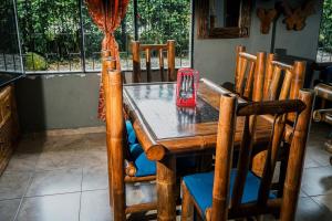 a wooden table with chairs and a red candle on it at Casa de Astilla in Mocoa