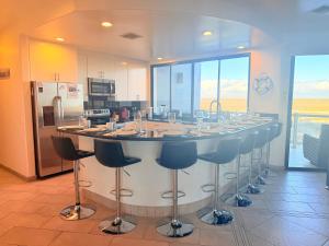a large island in a kitchen with a bar at Las Palomas OV 4BR 4BA Cortez 901 in Puerto Peñasco +76 photos