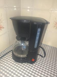 a black coffee maker sitting on top of a table at CASA MARY in Tequesquitengo