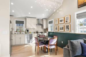 a kitchen and dining room with a table and chairs at Modern Design - Walk to Galleries + Beach + Dining in Provincetown