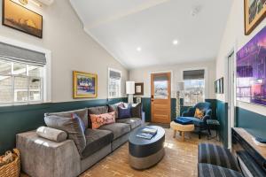a living room with a couch and a table at Modern Design - Walk to Galleries + Beach + Dining in Provincetown