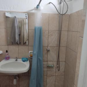 a bathroom with a shower and a sink at La Palmera Apartment in San Bartolo +3 photos