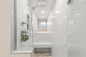 a white bathroom with a shower and a tub at Modern Design - Walk to Galleries + Beach + Dining in Provincetown +26 photos
