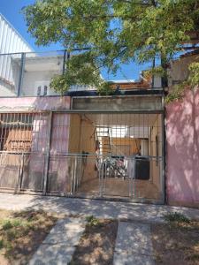 a garage with a gate with a motorcycle inside at Lo de Norma in Neuquén