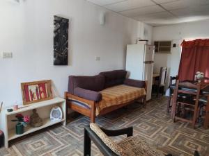 a living room with a couch and a refrigerator at Lo de Norma in Neuquén