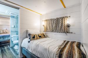 a small bedroom with a bed and a window at Mountain Top Cabin with a View - Bear Cabin in Ruidoso