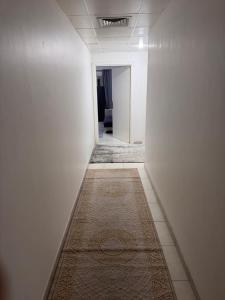 an empty hallway with a rug on the floor at Bedroom separately in Sharjah