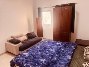 a living room with a bed and a couch at Bedroom separately in Sharjah
