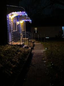 a house with lights on the front of it at night at Stay St Paul Haven in West Saint Paul