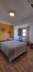 a bedroom with a large bed and a window at Edificio El Príncipe - Encarnación in Encarnación